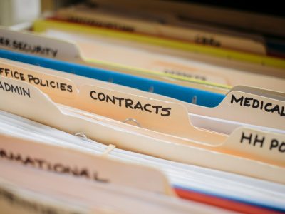 various medical record charts and folders in cabinet and on shelve sorted alphabetically and numerically